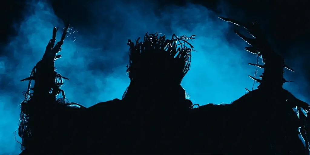 The black outline of a monstrous creature stands against the blue sky in a still from the Screambox series The Trouble with Tessa