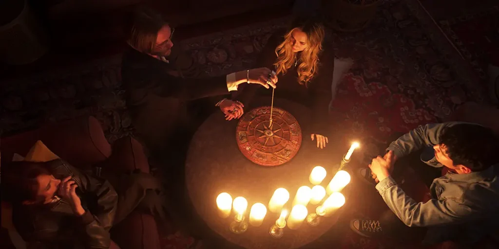 Mel Jarnson as “Brooke,” Jamie Campbell Bower as “Alexander Babtiste,” Madison Iseman as “Emily” and Aaron Dominguez as “Christian” in the movie Witchboard (2025)