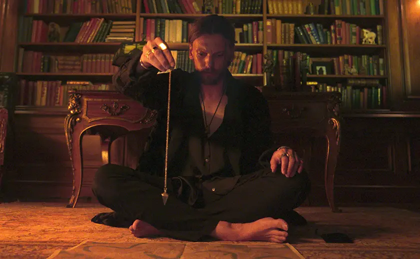 Jamie Campbell Bower as “Alexander Babtiste” in the movie Witchboard (2025)