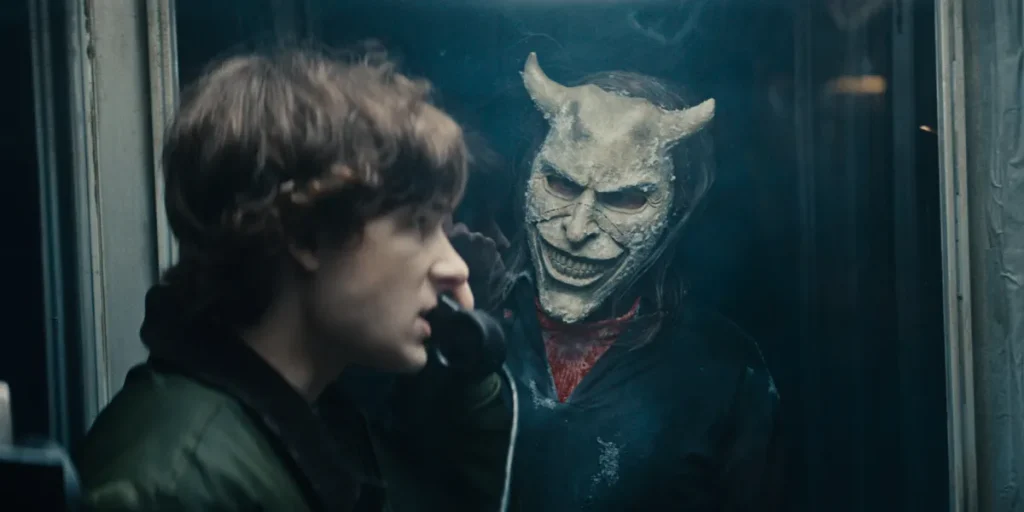 (from left) Finn (Mason Thames) and The Grabber (Ethan Hawke) are in a phone box in Black Phone 2