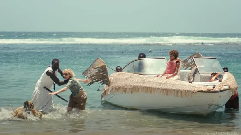 A boat with wings attached to it and some people in the sea in a still from the film Gavagai
