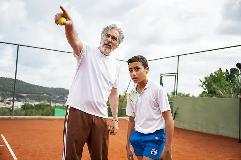 Andrea Di Stefano and Tiziano Menichelli in a behind the scenes photo from My Tennis Maestro (Il Maestro), whose director and star Pierfrancesco Favino we interview
