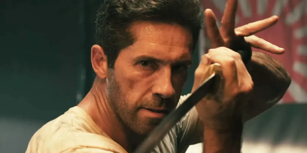 Scott Adkins holds a sword in a still from Prisoner of War