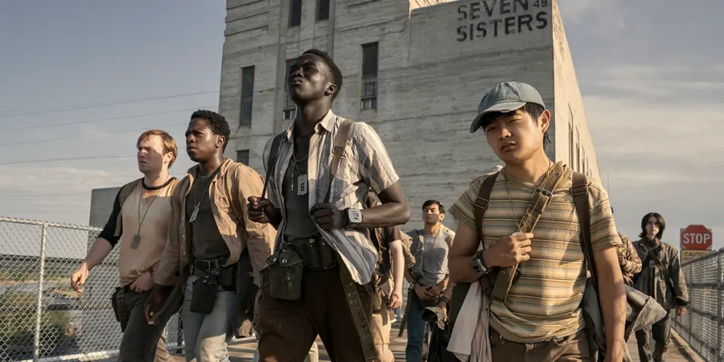 Young people walk away front of a building in a still from The Long Walk