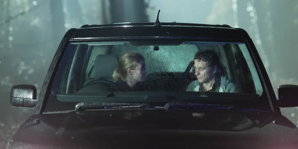 Rosamund Pike and Matthew Rhys are in a car at night in the film Hallow Road