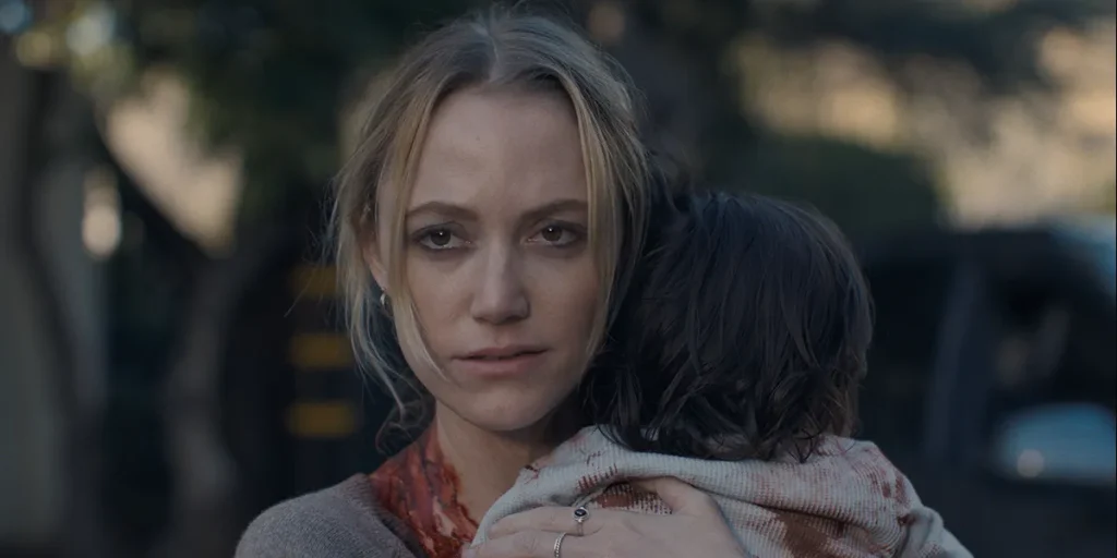 Maika Monroe holds a child in The Hand That Rocks The Cradle (2025)