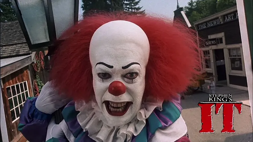 Pennywise in Stephen King's IT, one of the 10+ movies to watch on Halloween 2025 this year according to Loud And Clear Reviews