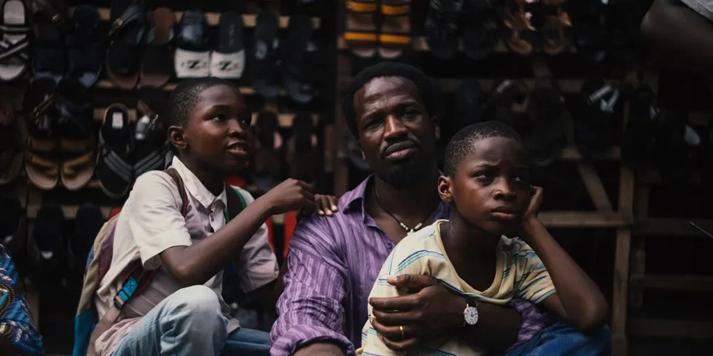 A father holds his two children in the movie My Father’s Shadow