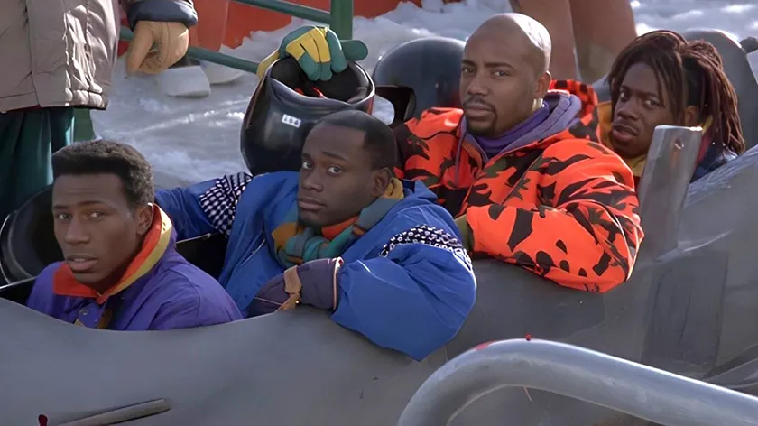Four men sit in a car in Cool Runnings (1993), one of the 10 Best Movies to Watch When You Feel Low ranked from worst to best by Loud and Clear Reviews