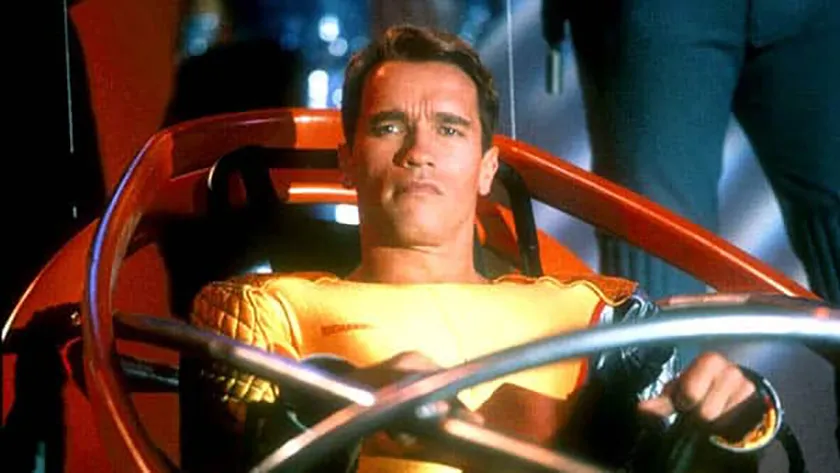 Arnold Schwarzenegger in a still from The Running Man, whose new movie (2025) is better than the original according to Loud And Clear Reviews