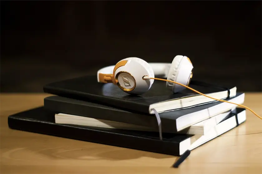 Sennheiser headphones resting on black notebooks