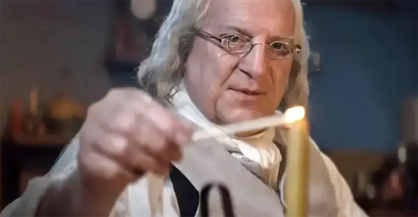 A man lights a candle in A Great Awakening