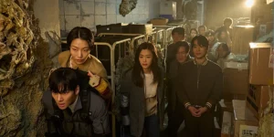 A group of people look ahead during a zombie apocalypse in a still from the movie Colony (Gun-Che)