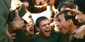 Soldiers group together preparing for war in a still from Lukas Dhont's Coward