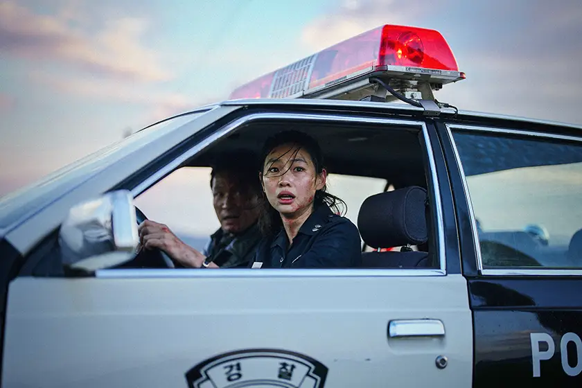 Hwang Jung-min and Hoyeon are in a police car in Hope (호프), from director Na Hong-Jin