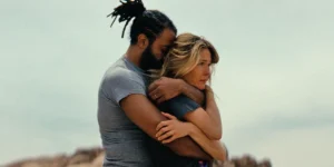 A man and a woman hug in a still from the film Magic Hour