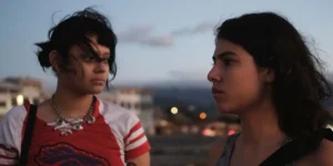 Two young women stand next to each other in the evening in a still from the movie Forever Your Maternal Animal (Siempre Soy tu Animal Materno)