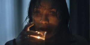 A woman holds a candle in Evil Dead Burn