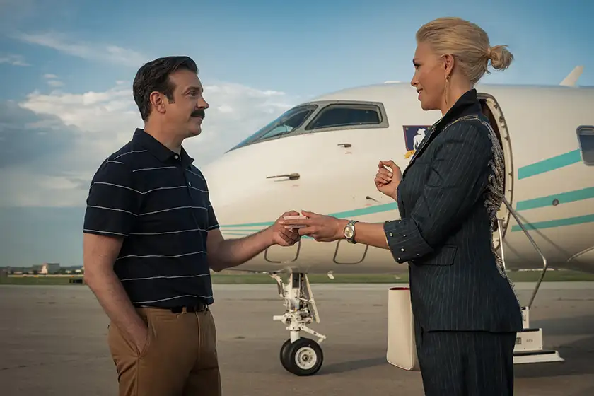 Jason Sudeikis and Hannah Waddingham exchange a pink box containing food in "Ted Lasso" Season 4, which this article explores everything you need to know about