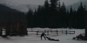 A man drags another man in the sand in a still from the Casey Affleck movie 'Company'