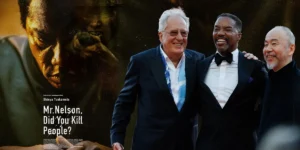 Geoffrey Rush, Rodney Hicks and Shinya Tsukamoto, whom we interview, on the red carpet for Mr. Nelson, Did You Kill People? in Venice, with the film poster next to them