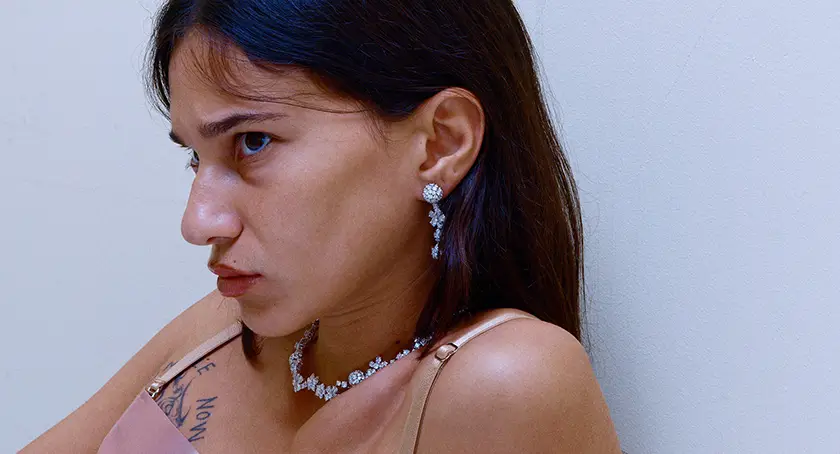Mia Kudis pouts while wearing expensive jewelry in the film French Girls, from writer-director Hyun Lee whom we interview